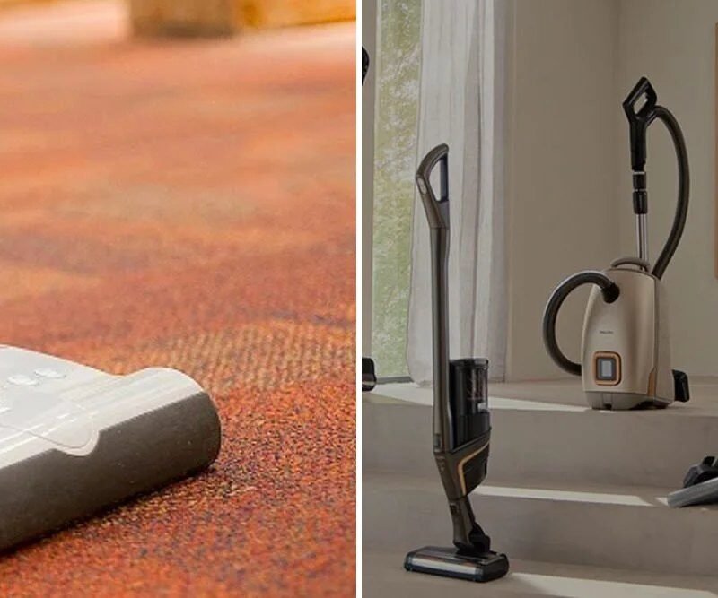 SEBO upright vacuum on carpet beside Miele stick and cylinder vacuums in a living room