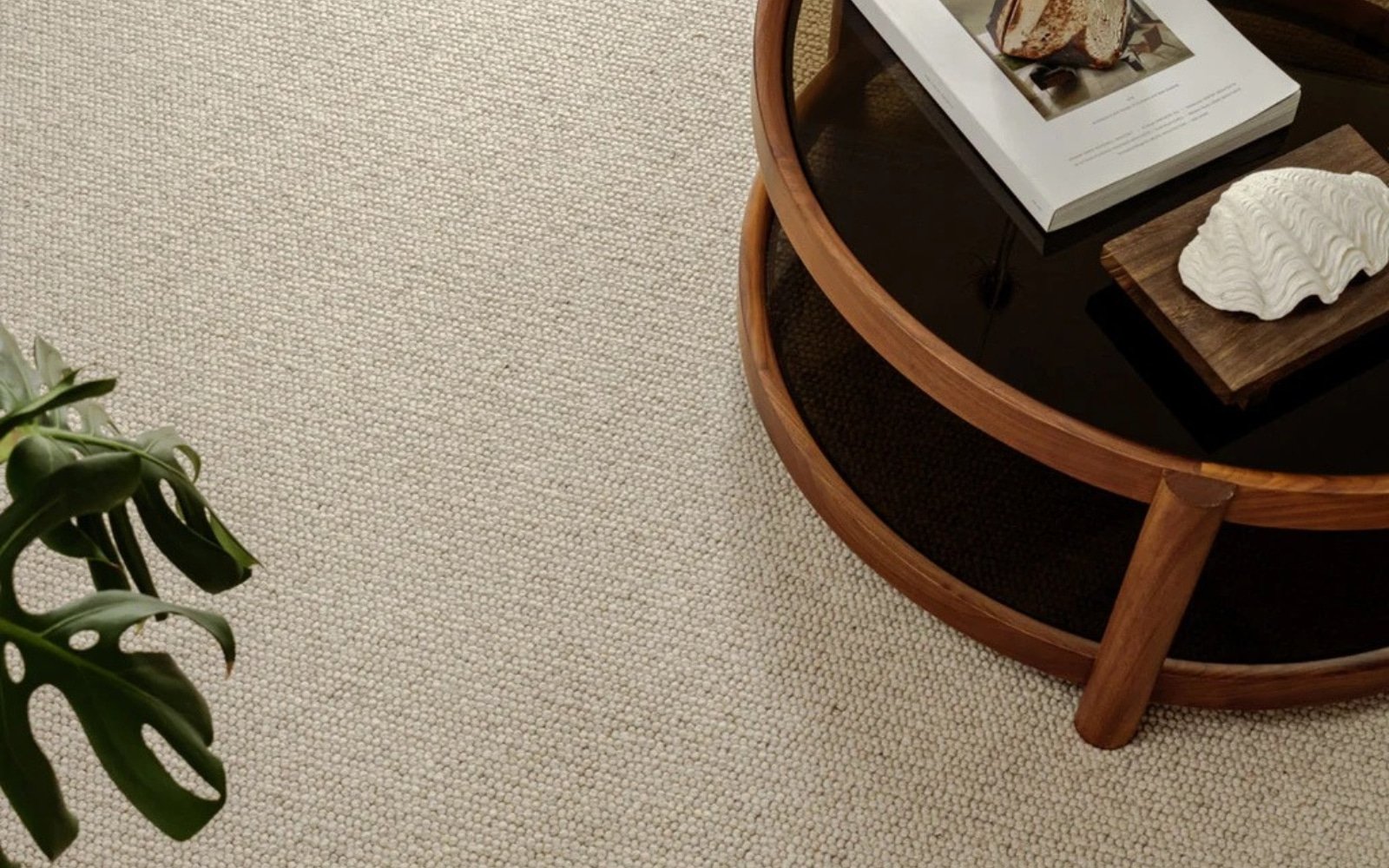 Natural wool loop-pile carpet in a living room with a round wooden coffee table